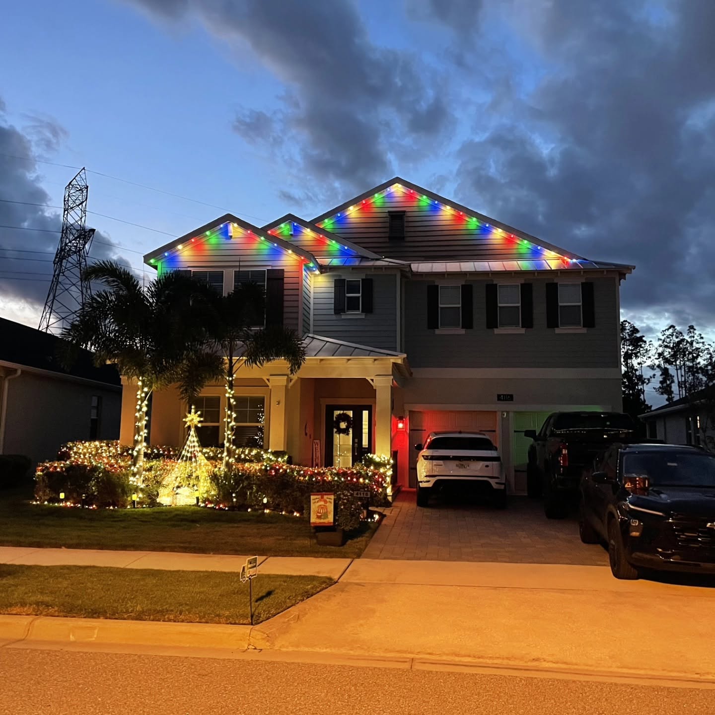 Two-story home with permanent exterior lights installed along the roofline